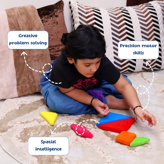 Child playing with colorful geometric shapes on a carpeted floor, surrounded by pillows.