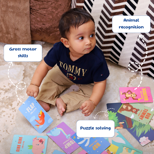 Child playing with educational cards on the floor, focusing on skills like animal recognition, gross motor skills, and puzzle solving.