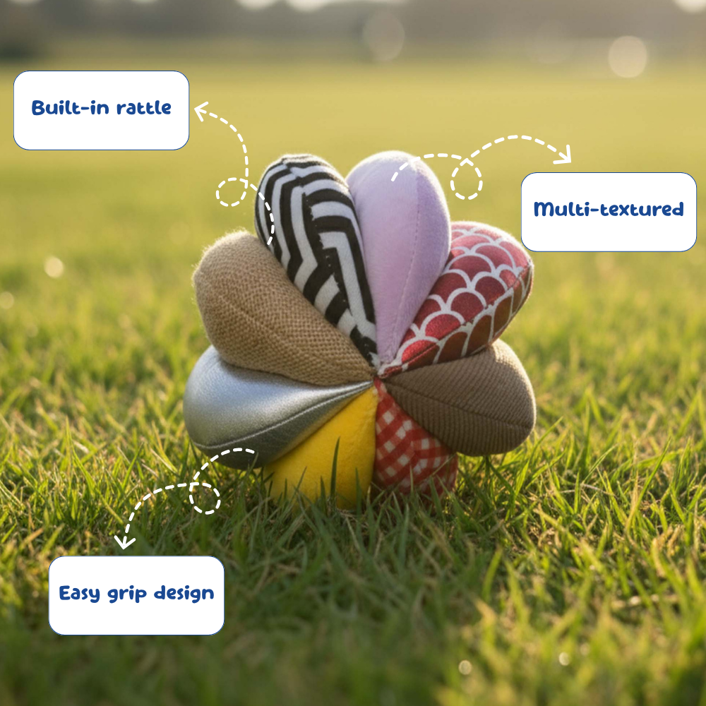 Colorful textured ball with built-in rattle on grass