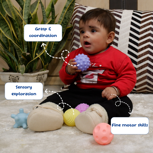 Child playing with colorful toys on a carpeted floor, with text labels on grasp, coordination, sensory exploration, and fine motor skills.
