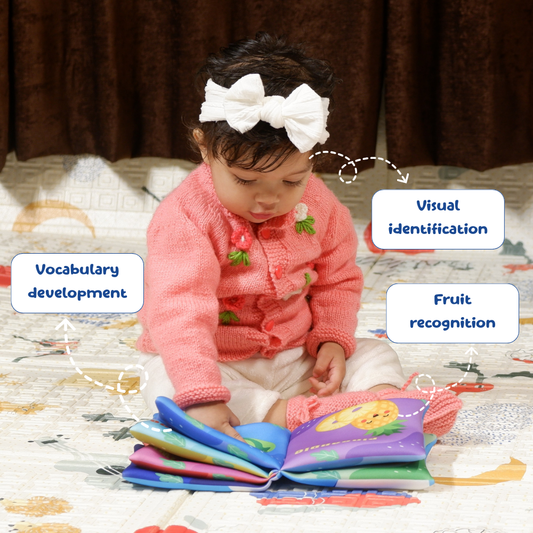 Child playing with a colorful soft book, promoting vocabulary development and fruit recognition.