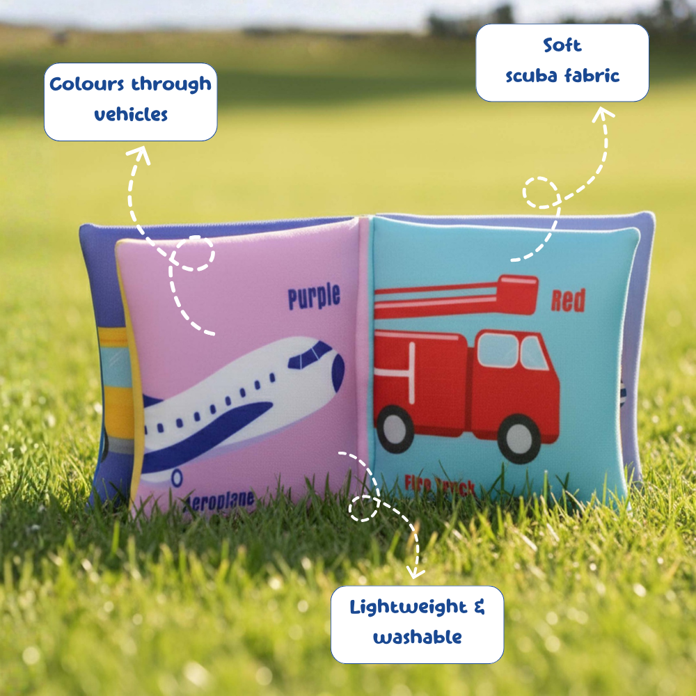 Children's soft book with airplane and fire truck illustrations on grass