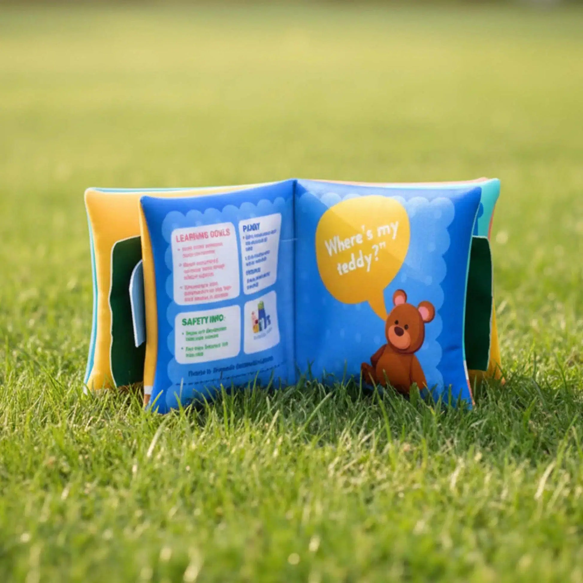 Children's book with a teddy bear on a grassy background